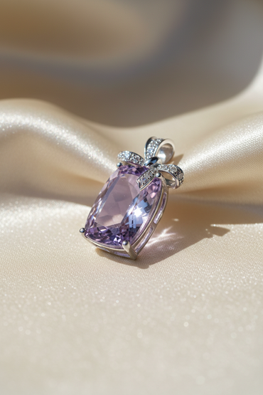 14K White Gold Cushion Amethyst and Diamond Bow Pendant - angled view on cream satin