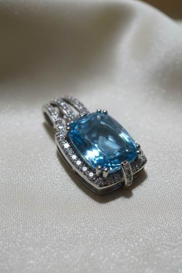 14K white gold cushion blue topaz and diamond halo pendant, three-quarter angle