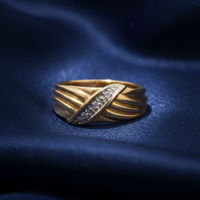 10K Yellow Gold Men's Two-Tone Diamond Crossover Ring on midnight blue silk backdrop editorial marketing image