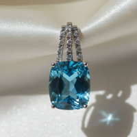 14K white gold cushion blue topaz and diamond triple bail pendant, top-down angle