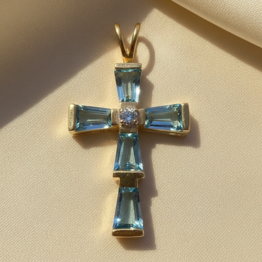 14K yellow gold cross pendant with baguette-cut blue topaz arms and round brilliant diamond center, angle 4